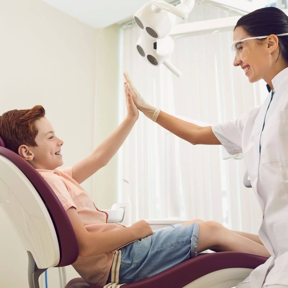 Young boy high-fiving his dentist