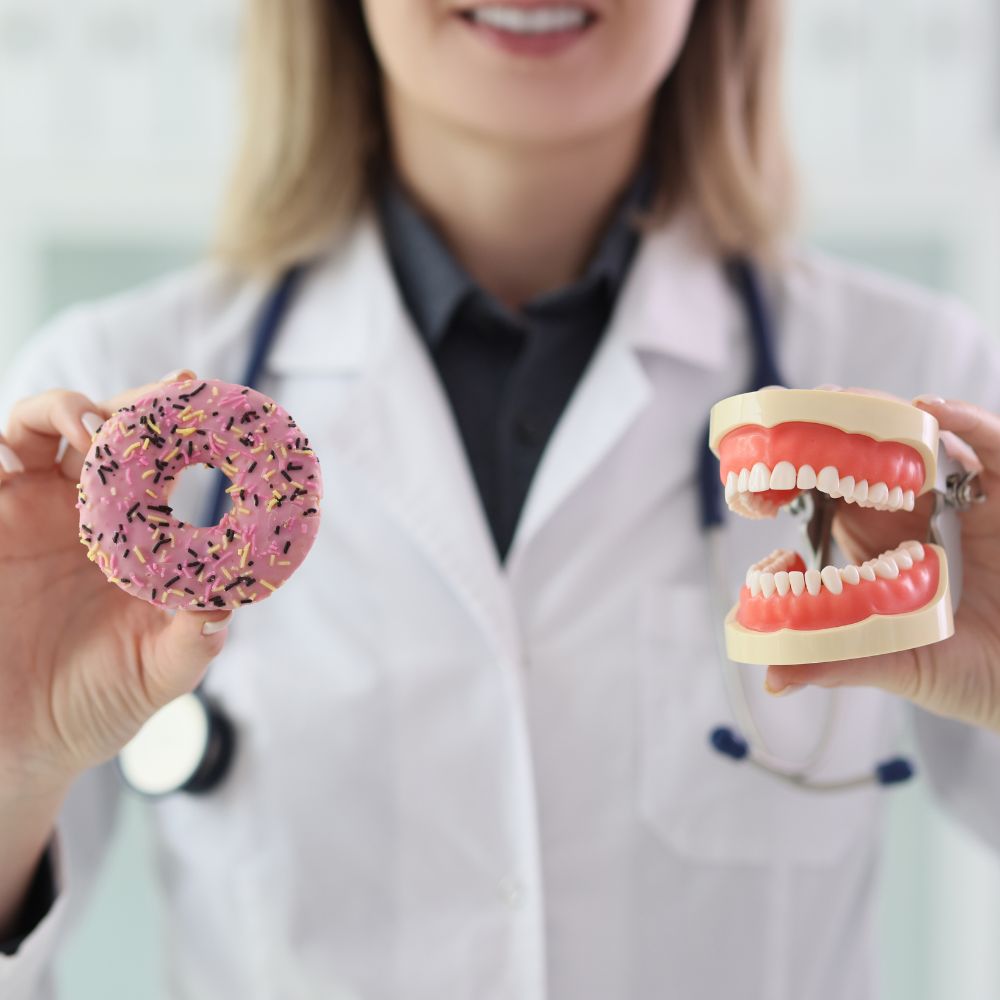 Dentist showing the affects of a donut on teeth