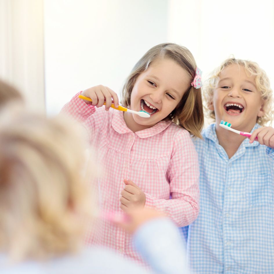 kids happily brushing their teeth
