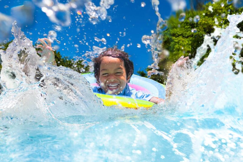 Child,In,Swimming,Pool,Floating,On,Toy,Ring.,Kids,Swim.