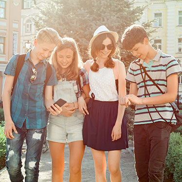 teens looking at phones