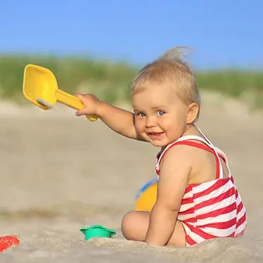 Baby playing in sand