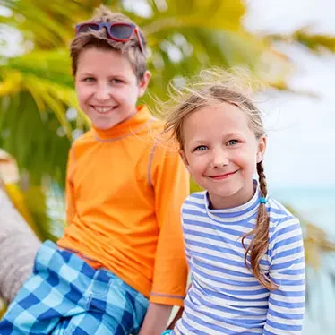 children smiling at beach